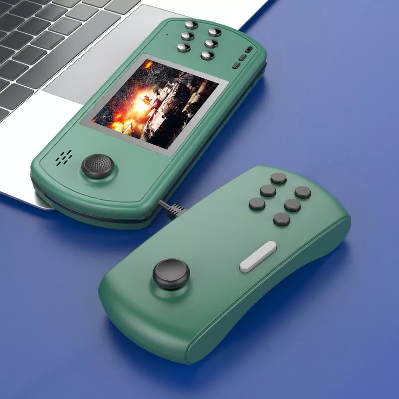Green handheld retro gaming console with detachable controller and action game on screen next to laptop